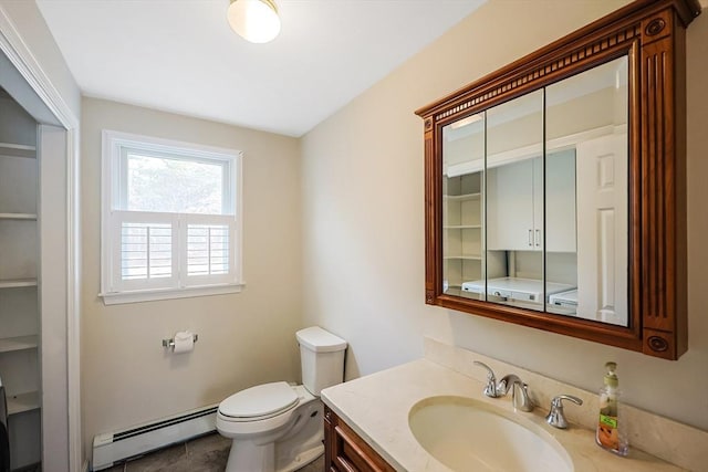 bathroom with a baseboard heating unit, toilet, and vanity