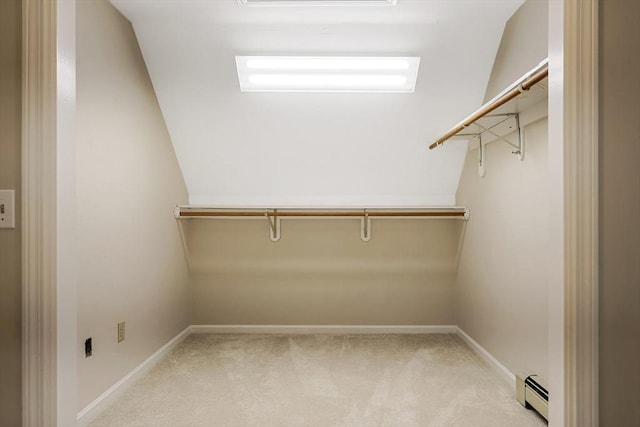 walk in closet featuring light carpet and baseboard heating