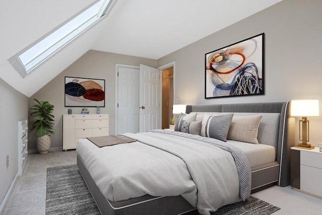 bedroom featuring baseboards, vaulted ceiling with skylight, light colored carpet, and a closet