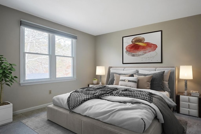 bedroom featuring baseboards and carpet flooring