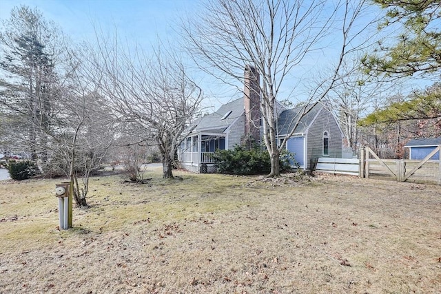 view of yard featuring a sunroom and fence