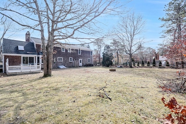 view of yard with a deck and fence