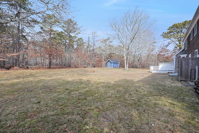 view of yard with a storage shed and an outbuilding