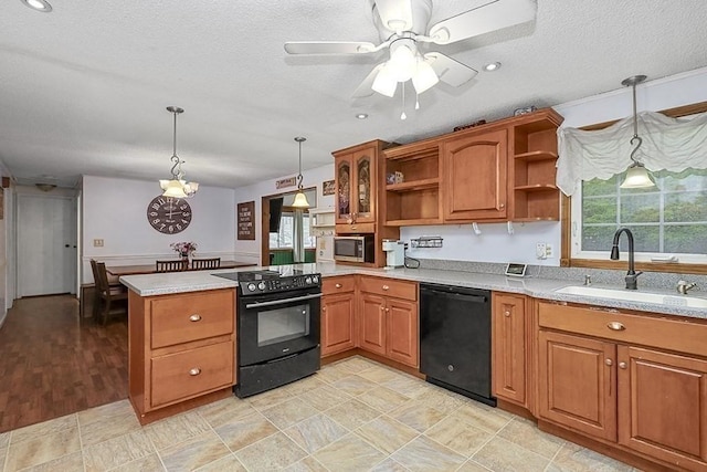 kitchen featuring black appliances, open shelves, a sink, a peninsula, and brown cabinets