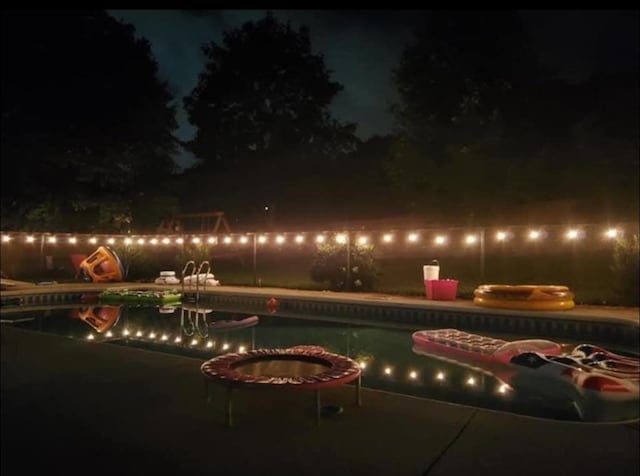 pool at night with an outdoor pool