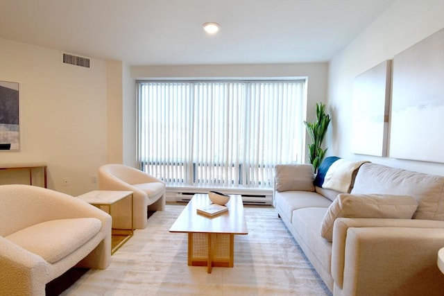 living room featuring baseboard heating and visible vents