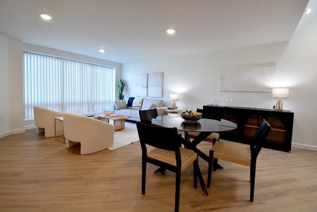 dining area featuring baseboards, light wood-style flooring, and recessed lighting