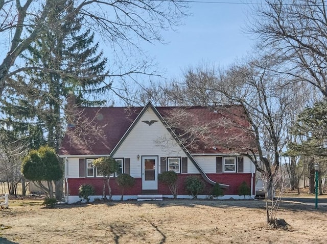 view of front of house featuring brick siding and a chimney