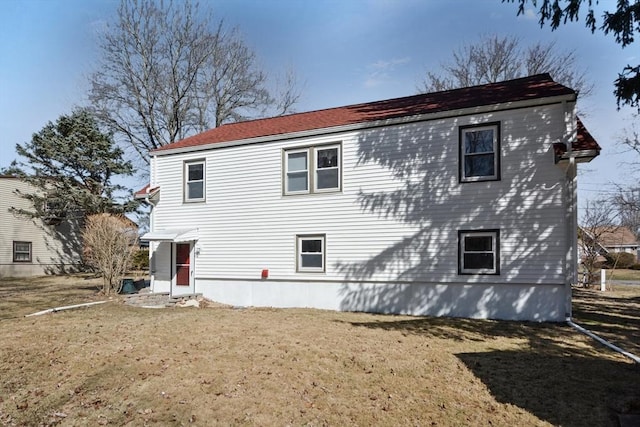 rear view of property with a yard