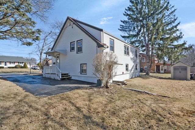 back of property with a storage unit and an outdoor structure