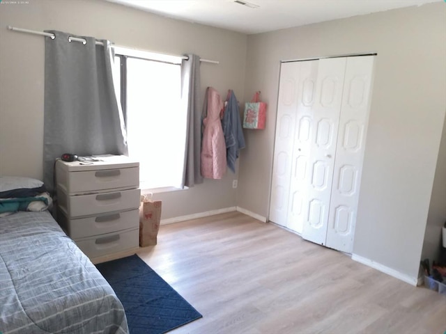 bedroom featuring light hardwood / wood-style floors and a closet