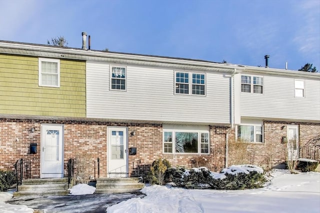 view of snow covered rear of property