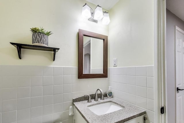 bathroom featuring vanity and tile walls