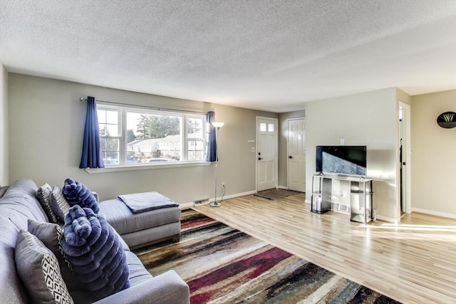 living room featuring hardwood / wood-style flooring and a textured ceiling