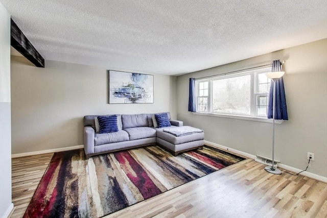 living room with hardwood / wood-style floors and a textured ceiling