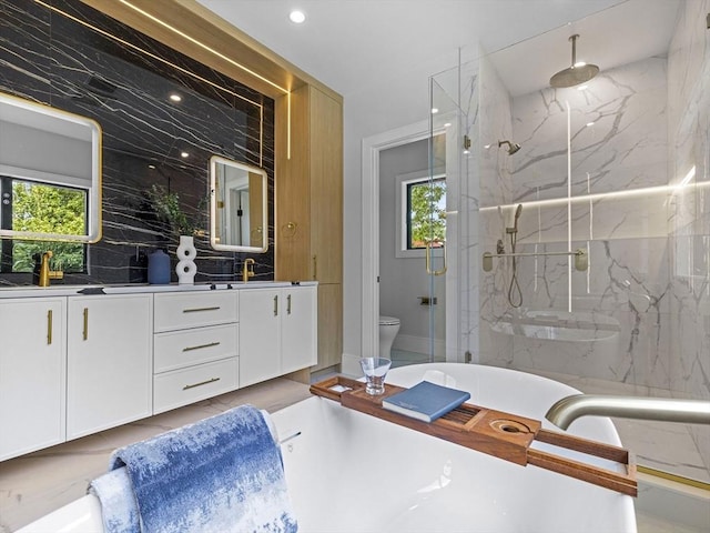 bathroom with vanity, toilet, tile walls, and an enclosed shower