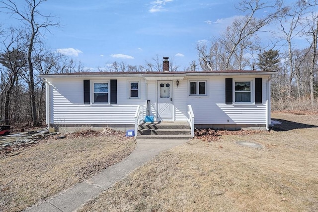 ranch-style home with entry steps and a chimney