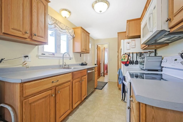 kitchen featuring light floors, light countertops, brown cabinetry, white appliances, and a sink