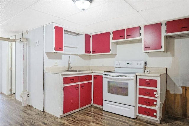 kitchen featuring dark wood finished floors, red cabinetry, white electric stove, a paneled ceiling, and a sink