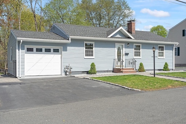single story home with aphalt driveway, a front yard, roof with shingles, a chimney, and an attached garage