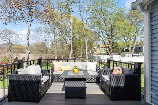 wooden deck featuring a fenced backyard and an outdoor hangout area