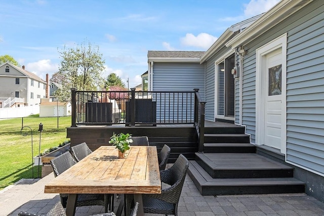 view of patio with outdoor dining space and a deck