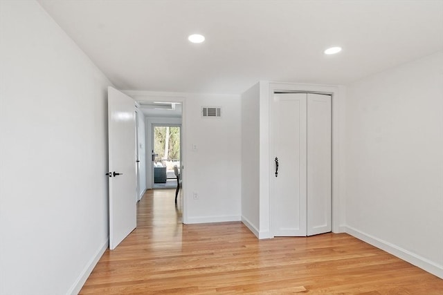 unfurnished bedroom featuring visible vents, a closet, baseboards, recessed lighting, and light wood-style flooring