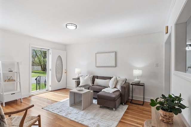 living room featuring baseboards and light wood finished floors