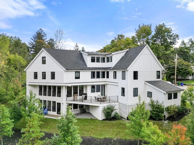 rear view of property with a yard