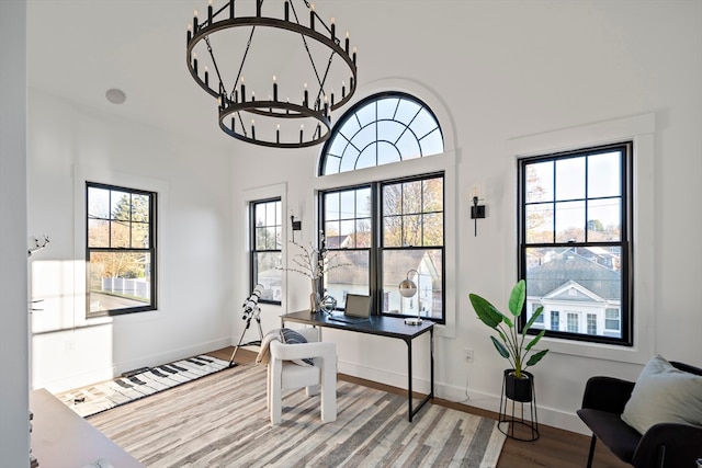 office featuring hardwood / wood-style flooring, plenty of natural light, and a chandelier