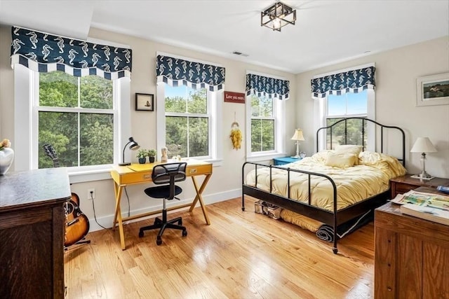 6 Macdonald Ter Unit E, Scituate, MA 02066 - bedroom with wood finished floors, multiple windows, a desk, and baseboards