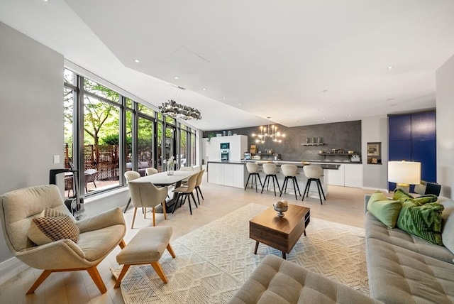 living room featuring a chandelier, healthy amount of natural light, and recessed lighting