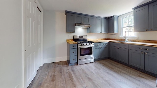 54 Hazard St, New Bedford, MA 02740 - kitchen with stainless steel range with gas stovetop, under cabinet range hood, and gray cabinetry