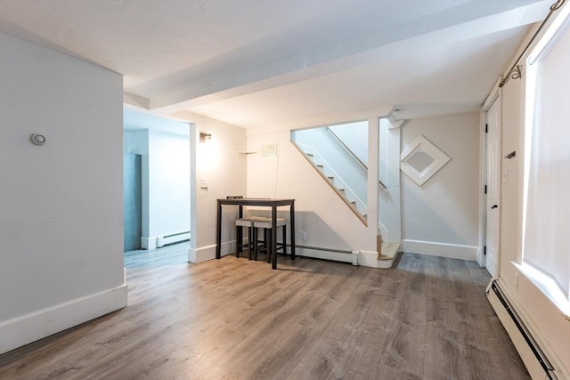 54 Hazard St, New Bedford, MA 02740 - spare room featuring a baseboard heating unit, wood finished floors, and stairway