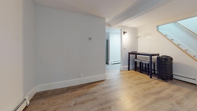 54 Hazard St, New Bedford, MA 02740 - empty room featuring a baseboard heating unit, wood finished floors, beam ceiling, stairway, and a baseboard radiator
