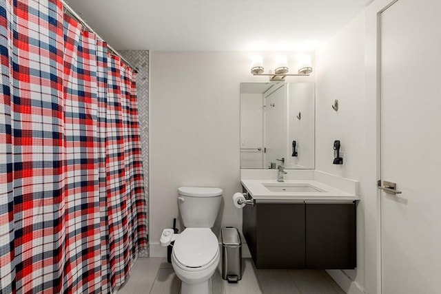 bathroom featuring vanity, tile patterned floors, and toilet