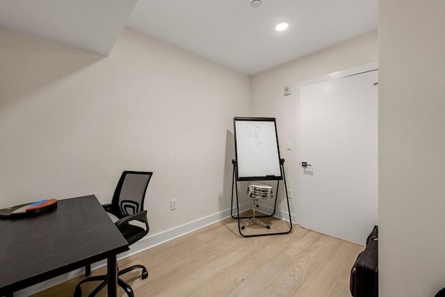 office with light hardwood / wood-style flooring