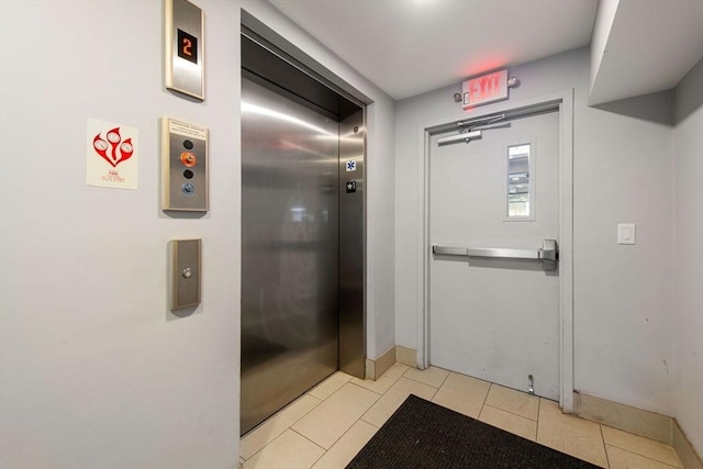 interior space featuring elevator and tile patterned flooring