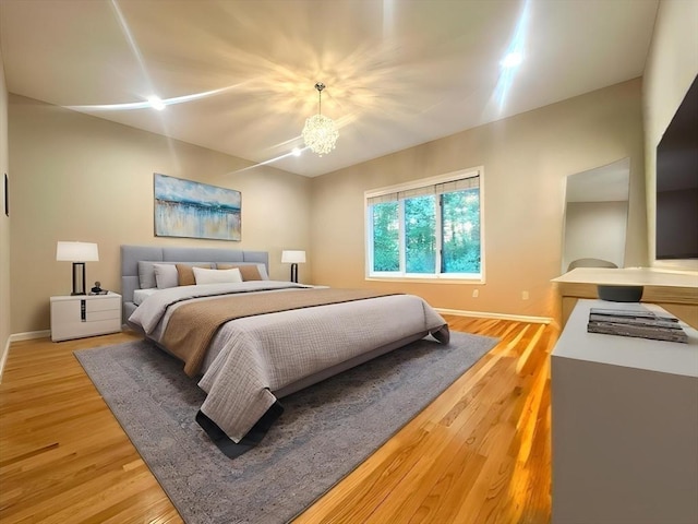 104 Channing Rd, Concord, MA 01742 - bedroom with light wood-style floors, baseboards, and a chandelier