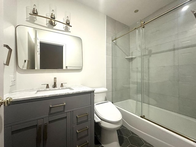 104 Channing Rd, Concord, MA 01742 - full bath with toilet, vanity, tile patterned floors, and bath / shower combo with glass door