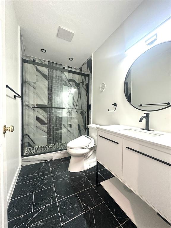 104 Channing Rd, Concord, MA 01742 - full bathroom with toilet, marble look tiles, vanity, a stall shower, and recessed lighting