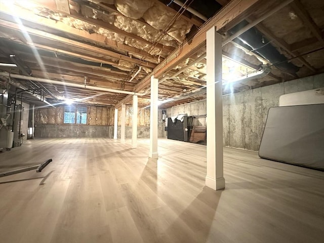 104 Channing Rd, Concord, MA 01742 - basement featuring wood finished floors and heating unit