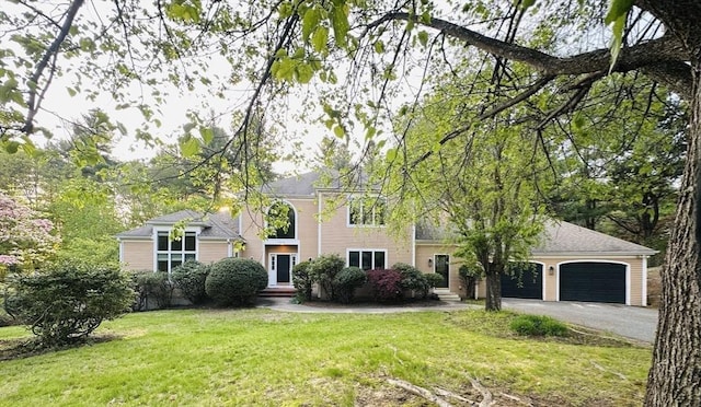 104 Channing Rd, Concord, MA 01742 - view of front of house with a front yard, asphalt driveway, and a garage