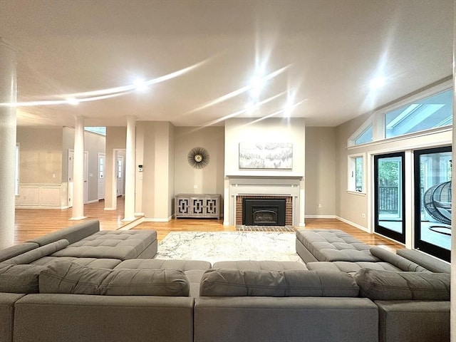 104 Channing Rd, Concord, MA 01742 - living room with light wood-style flooring, baseboards, and a brick fireplace
