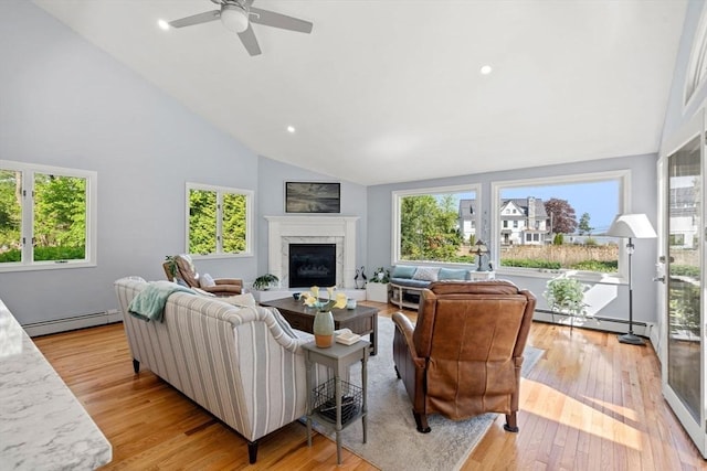 6 Riverview Dr, Newburyport, MA 01950 - living room featuring high vaulted ceiling, a baseboard heating unit, a fireplace, ceiling fan, and light wood-style flooring