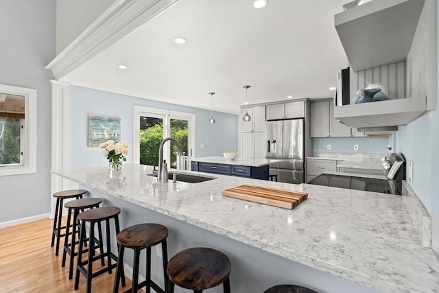 6 Riverview Dr, Newburyport, MA 01950 - kitchen with stainless steel fridge, a sink, light wood-style floors, light stone countertops, and range