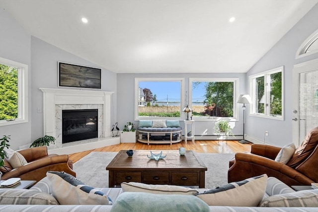 6 Riverview Dr, Newburyport, MA 01950 - living area with vaulted ceiling, a baseboard heating unit, wood finished floors, recessed lighting, and a high end fireplace