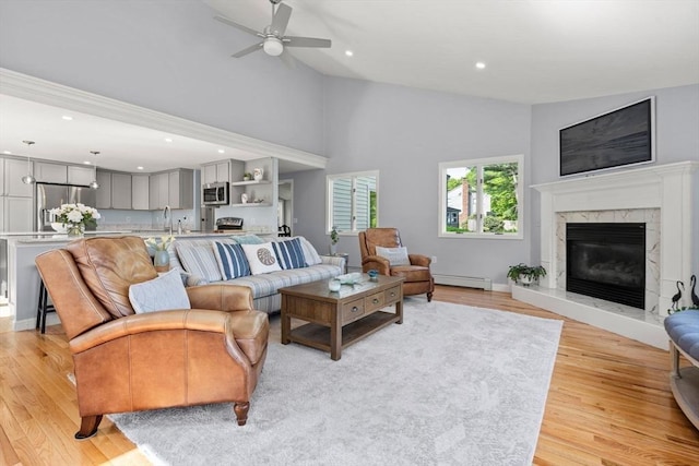 6 Riverview Dr, Newburyport, MA 01950 - living room featuring ceiling fan, light wood-type flooring, a baseboard radiator, a premium fireplace, and recessed lighting