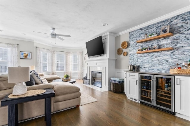 living area with a bar, wine cooler, dark wood-style flooring, and crown molding