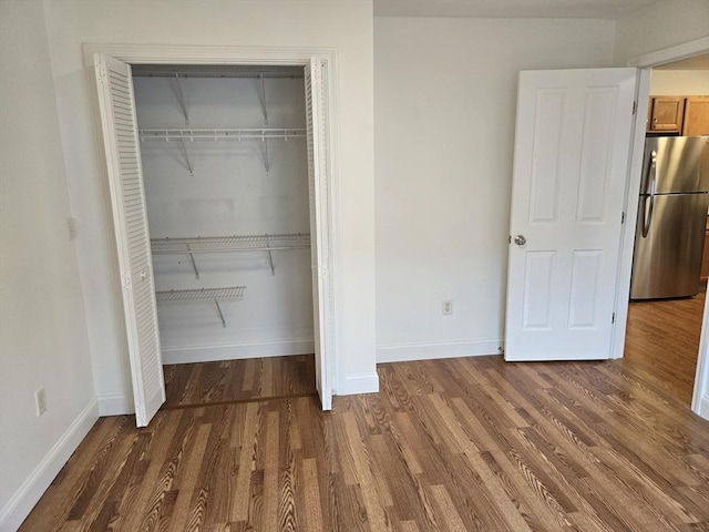 315 Cambridge St Unit 302A, Worcester, MA 01603 - unfurnished bedroom featuring freestanding refrigerator, wood finished floors, and a closet